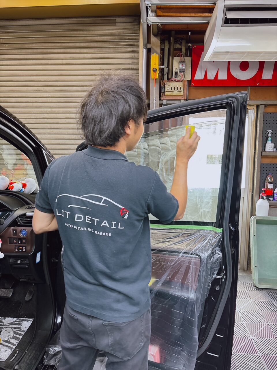 カーフィルム施工前にガラス内側を専用の下処理剤で研磨し、内張りと電装部品を養生した状態|大阪・門真 LIT DETAIL